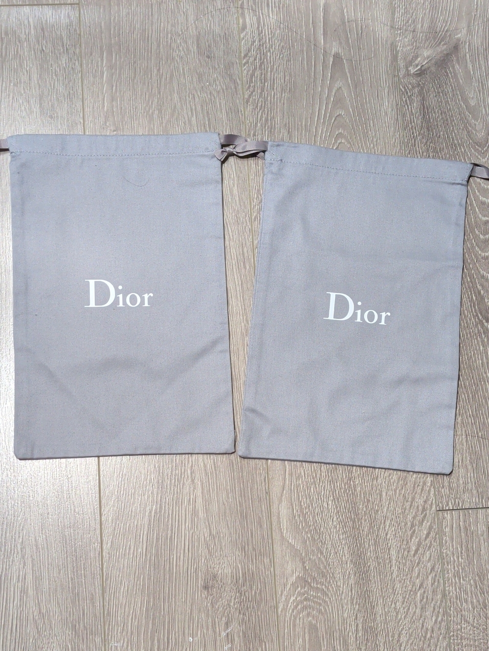Dior. Pair Of duster Bags.